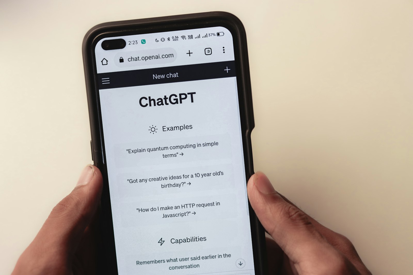 Person holding a phone with a chat app on the screen