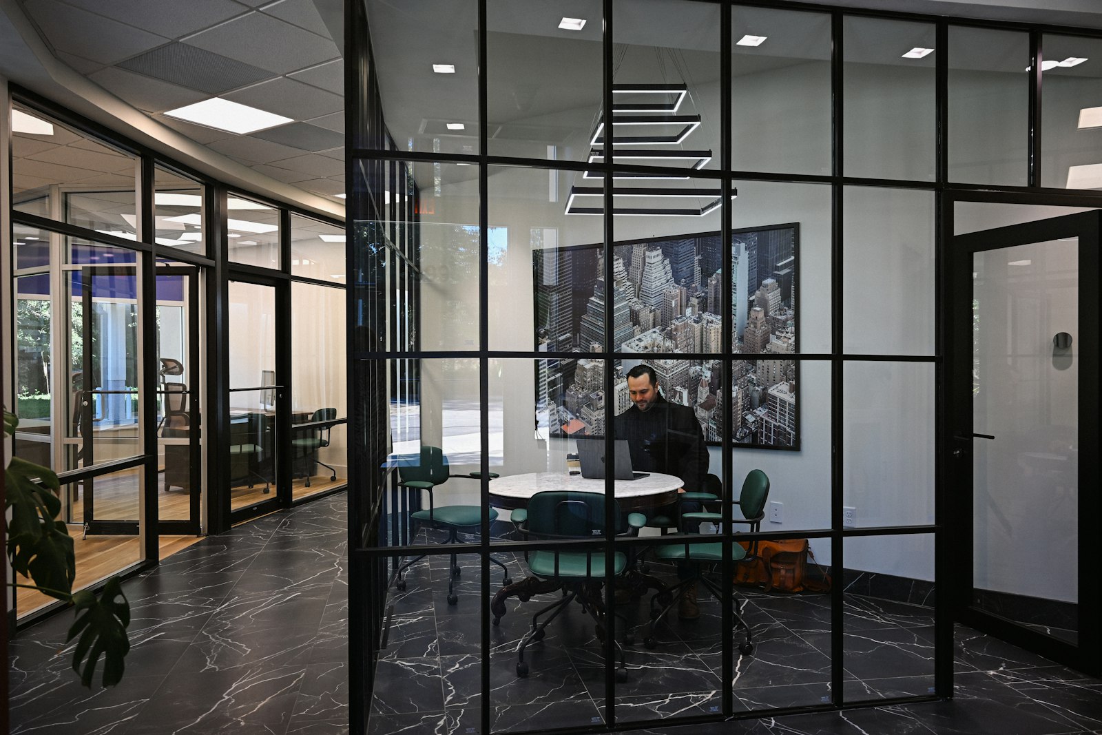 Professional reviewing business documents and working on a laptop in a modern office