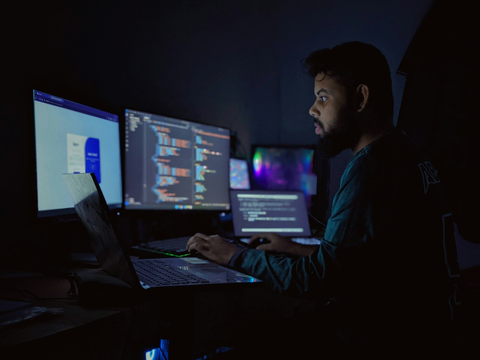 Developer working across multiple monitors on custom software