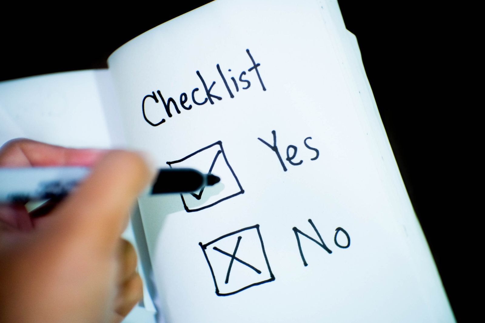 Person checking off items on a decision checklist