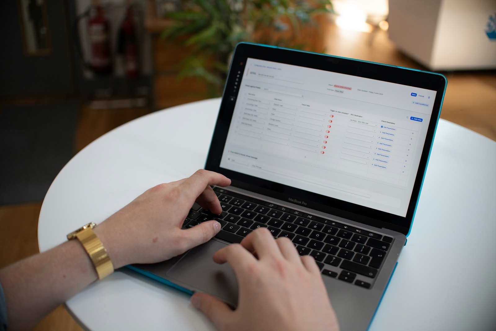 Hands typing on a laptop with a spreadsheet open, representing business process work