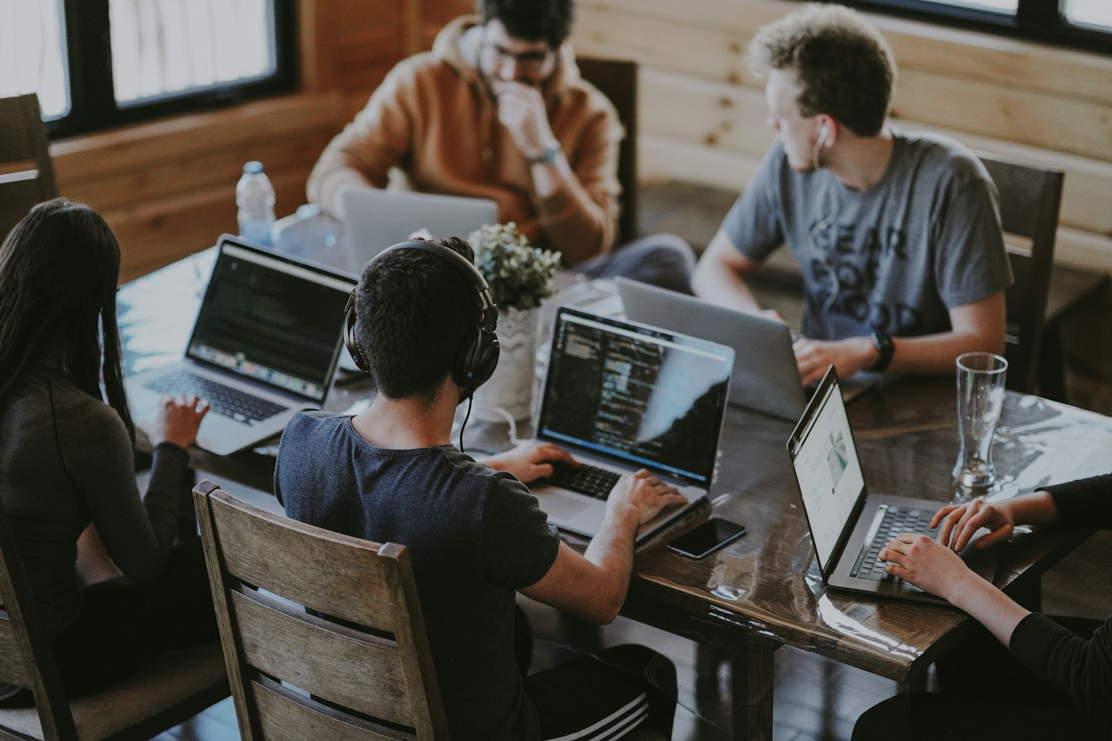 Team collaborating around a laptop in an office