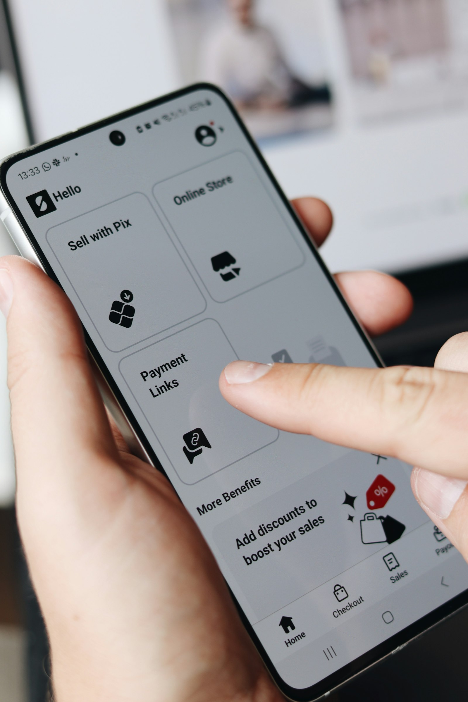 Close-up of a person holding a smartphone and using a mobile ordering app interface