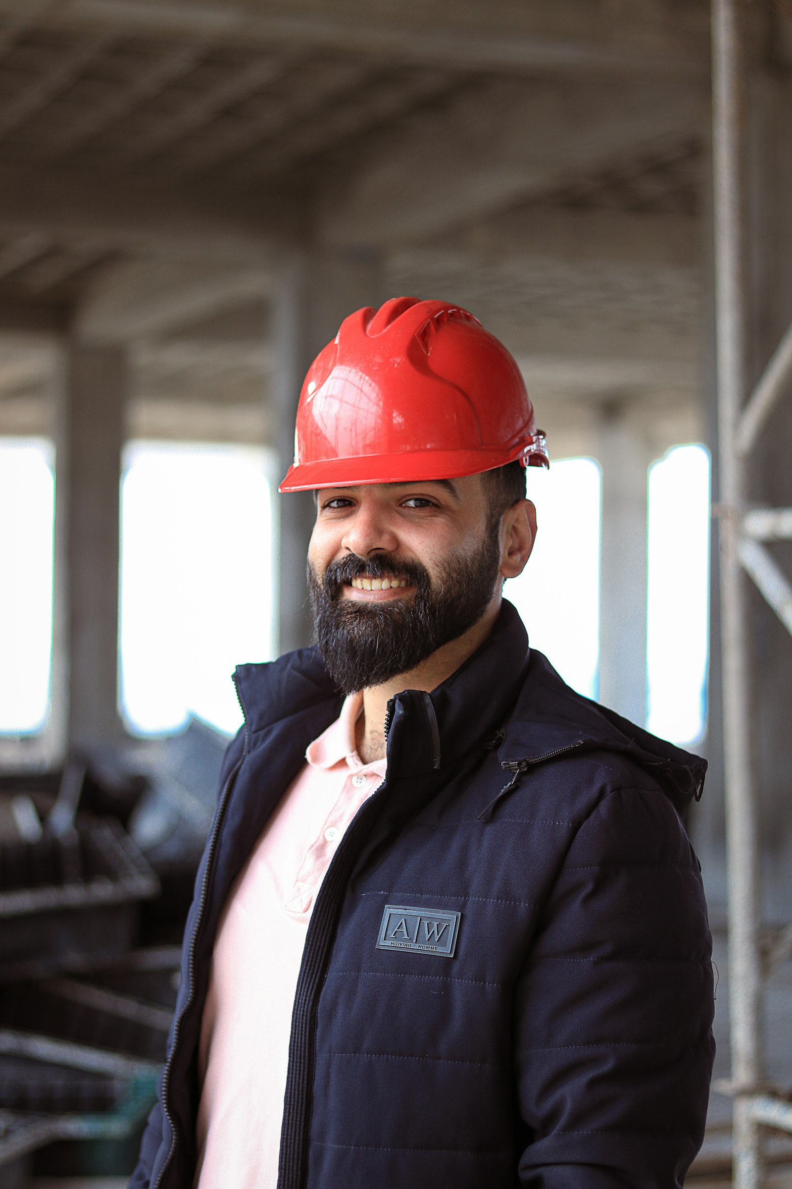 Construction engineer reviewing site documents with a tablet