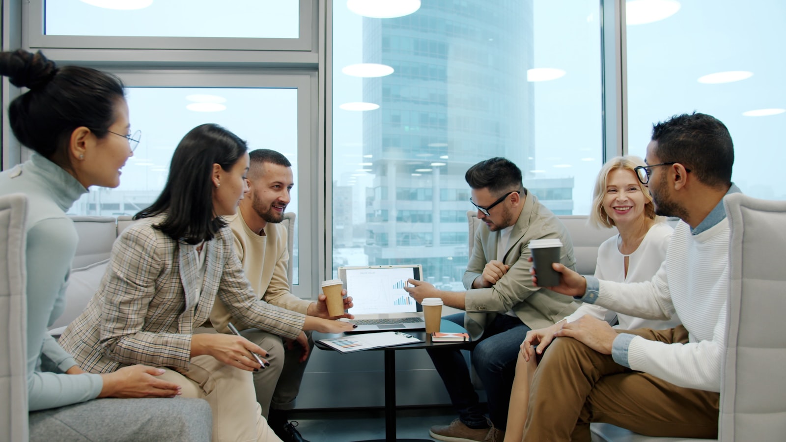 Diverse team collaborating in a modern office meeting