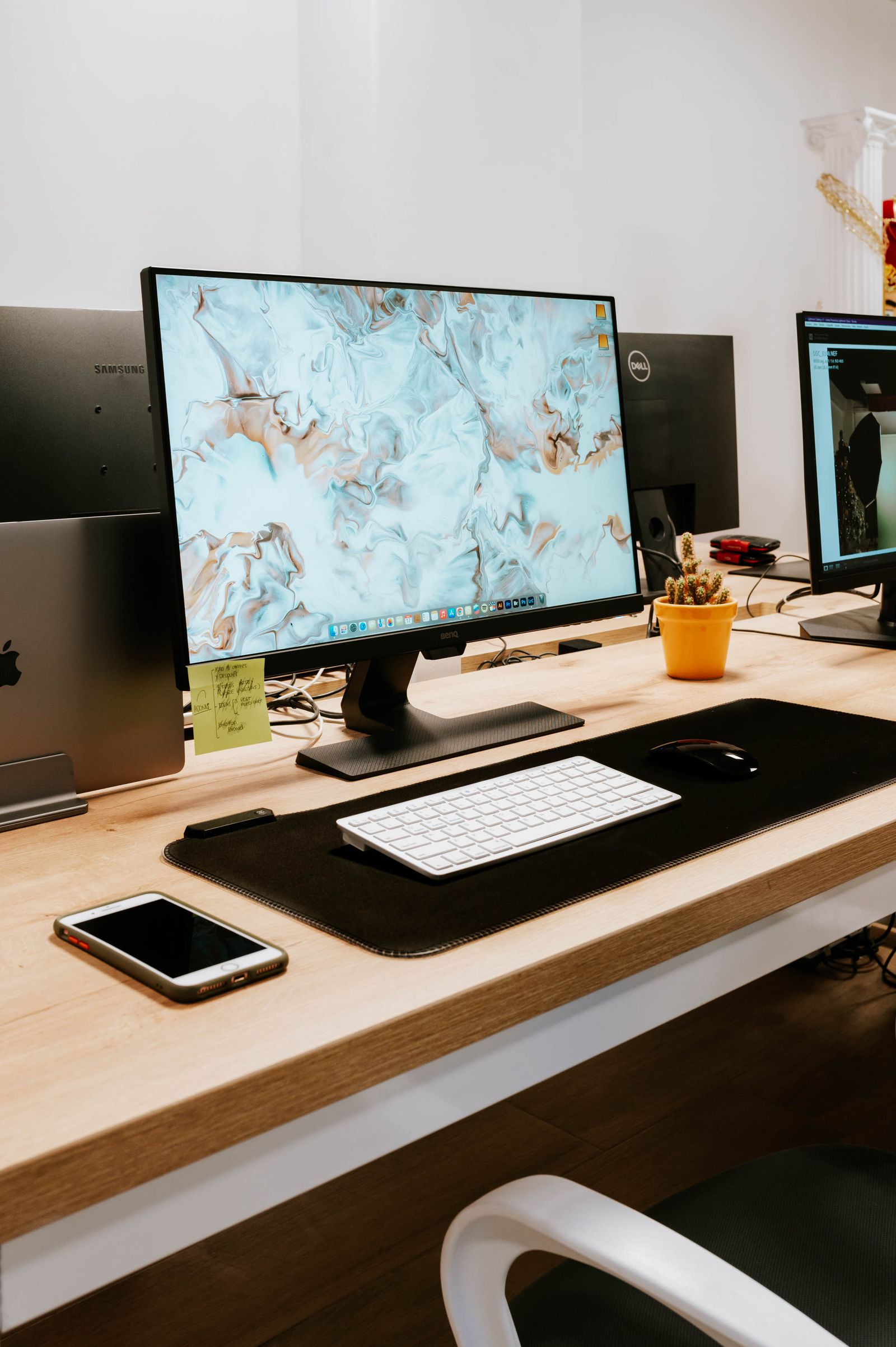 Smartphone and laptop side by side on a desk
